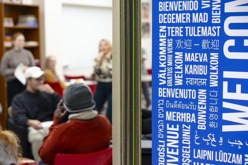 International center at lucille little library with graphic of languages on a wall